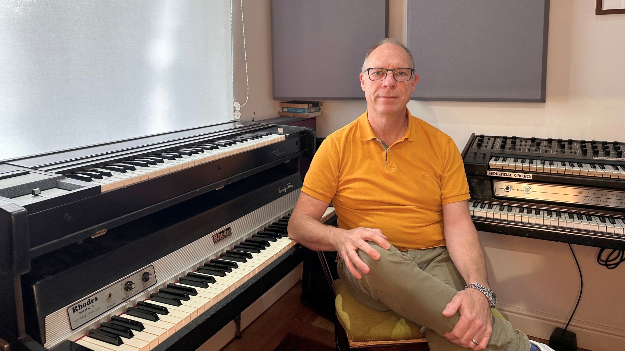 Andy Whitmore seated among vintage keyboards at Greystoke Studio