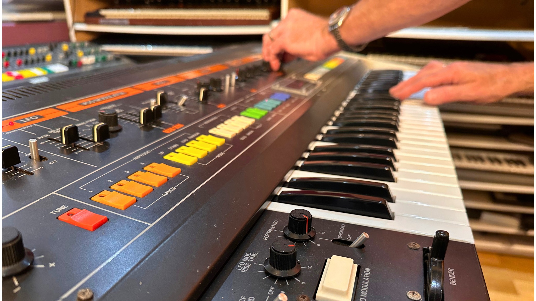 Hands playing and adjusting a Roland Jupiter-8 at Greystoke Studio